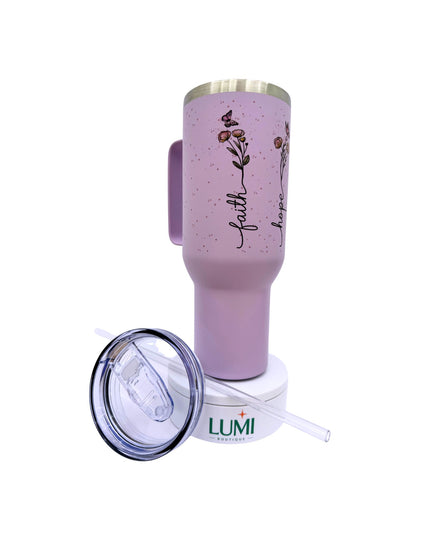 Pink tumbler with floral design and 'faith' text, featuring Lumi logo.