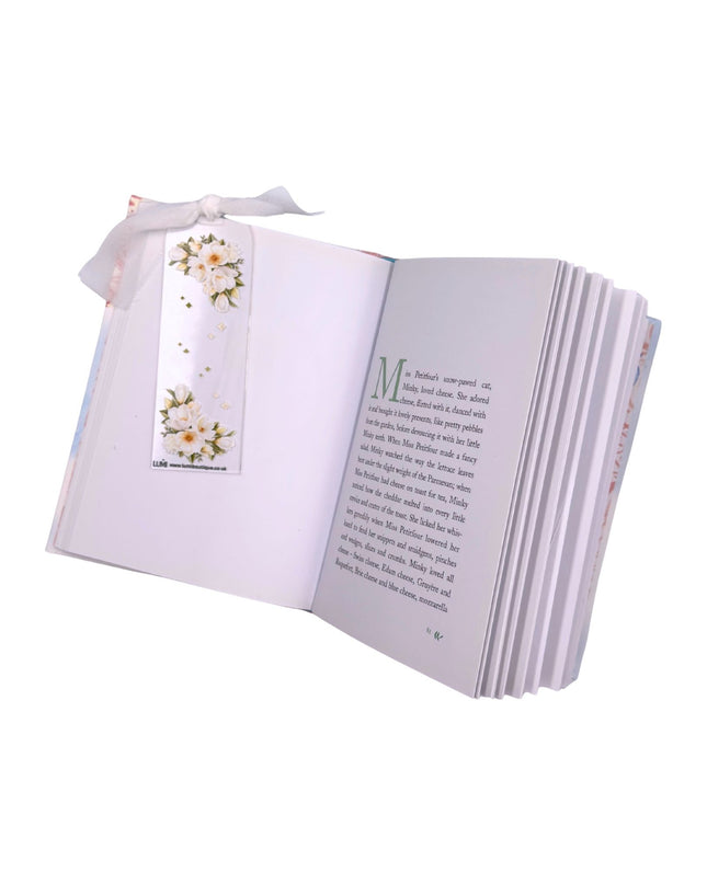 Open book with a bookmark featuring floral design on a white background