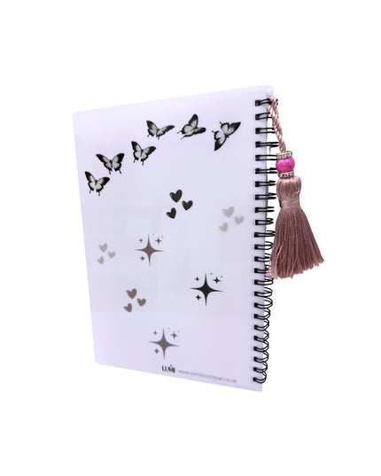 Notebook with butterfly and star patterns on a white background