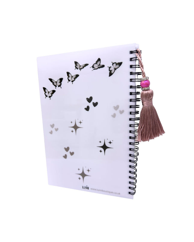 Notebook with butterfly and star patterns on a white background