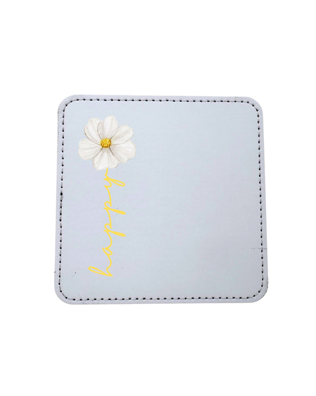 coaster with a white daisy and 'happy' text on a white background