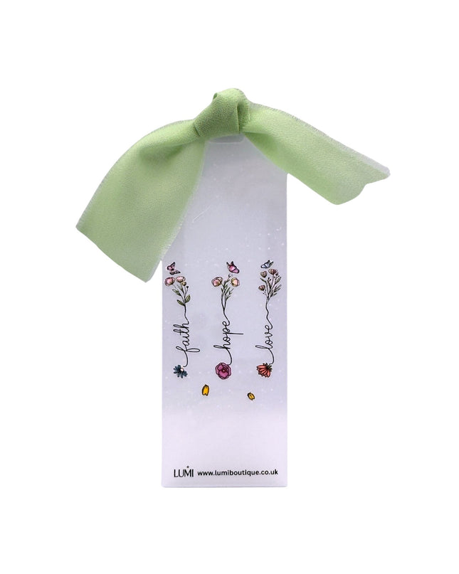 Bookmark with floral design and green ribbon on a white background