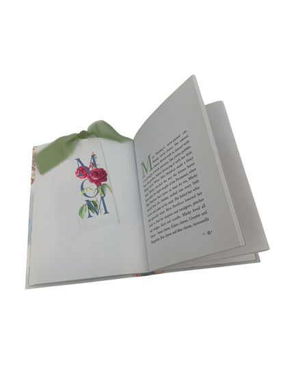 Open book with floral design on a white background