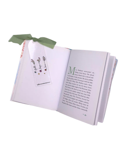 Open book with a bookmark and decorative ribbon on a white background