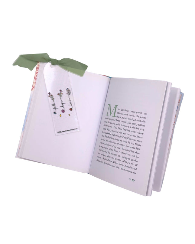 Open book with a bookmark and decorative ribbon on a white background