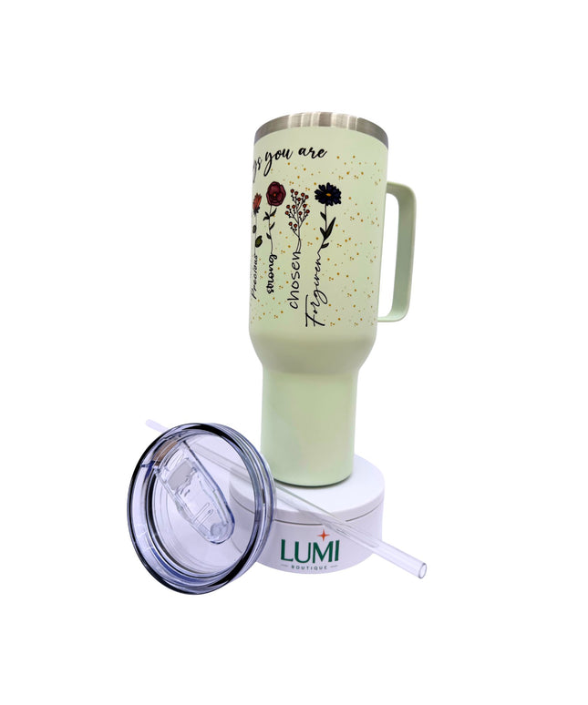 Light green mug with floral designs and text, featuring a Lumi straw lid on a white background