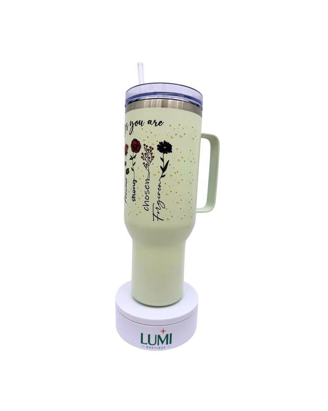 Light green tumbler with floral design and text on a white background, featuring the LUMI logo.