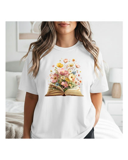Person wearing a white t-shirt with a floral book design in a room.