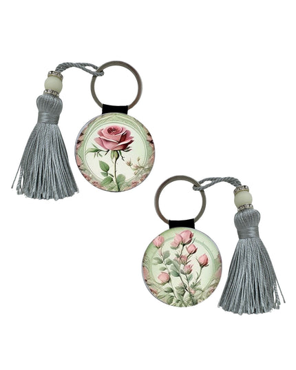 Two floral keychains with tassels on a white background