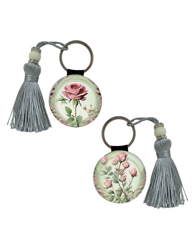 Two floral keychains with tassels on a white background