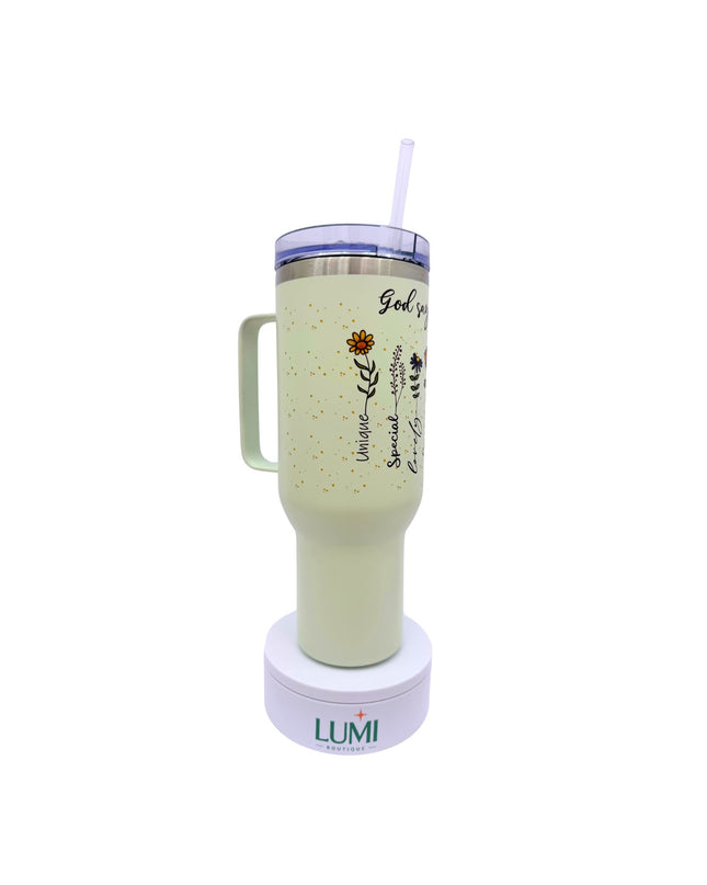 Light green tumbler with handle and straw on a white background