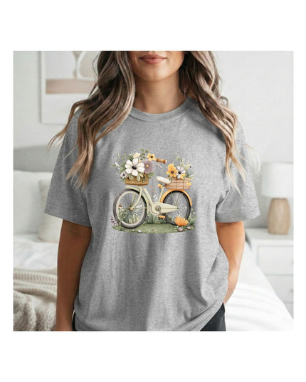 Person wearing a gray t-shirt with a bicycle and flower basket graphic.