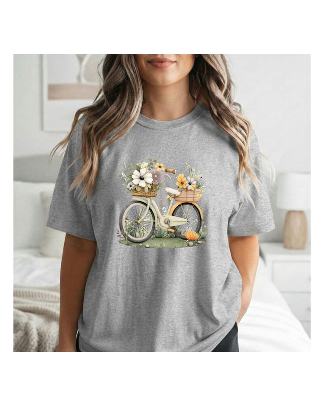 Person wearing a gray t-shirt with a bicycle and flower basket graphic.