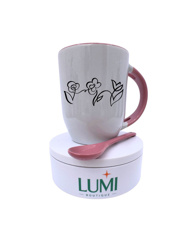 White mug with floral design and pink handle on a white base with 'LUMI' branding.