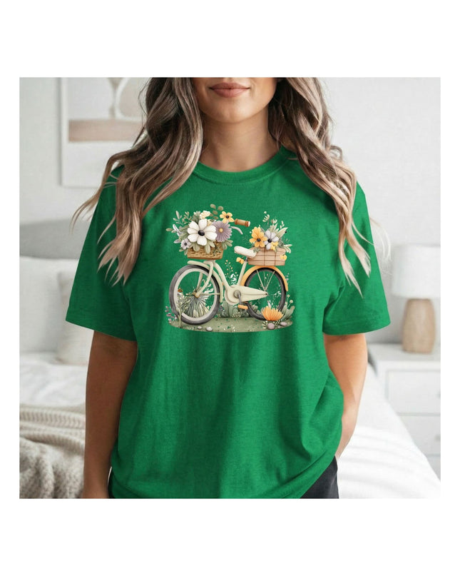 Person wearing a green t-shirt with a bicycle and flower design.