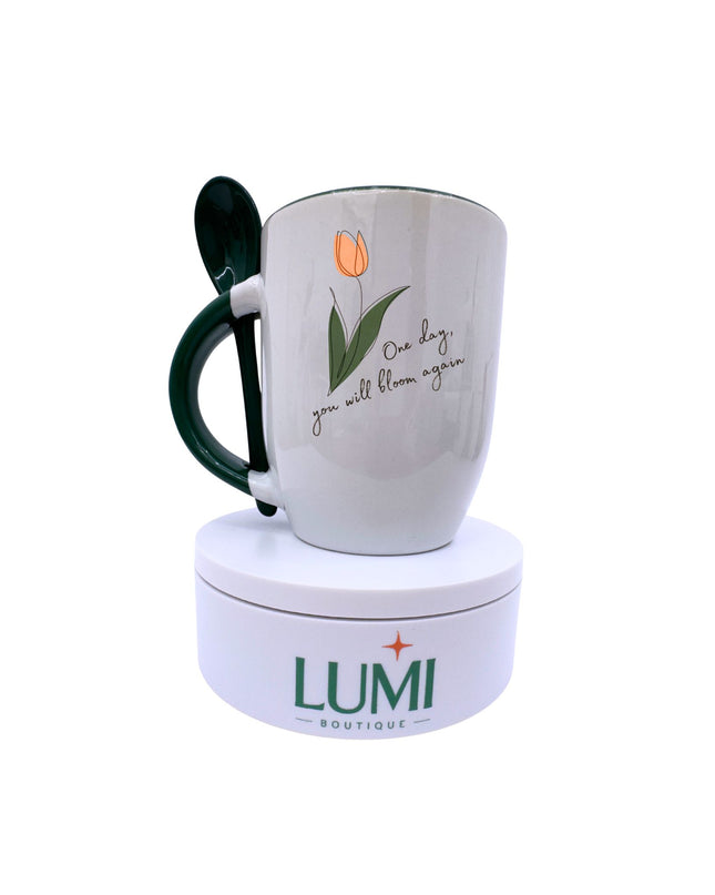 Mug with tulip design and text, placed on a white stand with 'LUMI Boutique' branding.