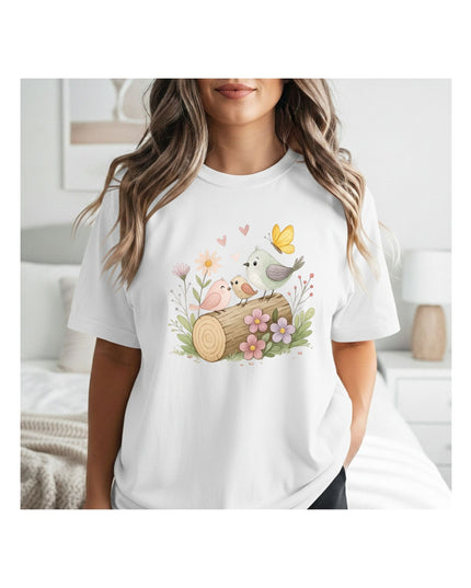 Woman wearing a white t-shirt with a nature-themed design featuring birds and flowers.