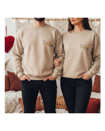 beige sweatshirts with text and heart designs.