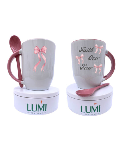 Two mugs with pink spoons and decorative bows, branded 'LUMI Boutique', on a white background.