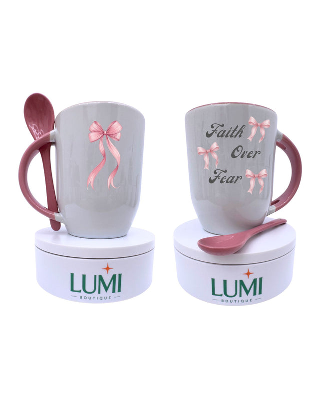 Two mugs with pink spoons and decorative bows, branded 'LUMI Boutique', on a white background.