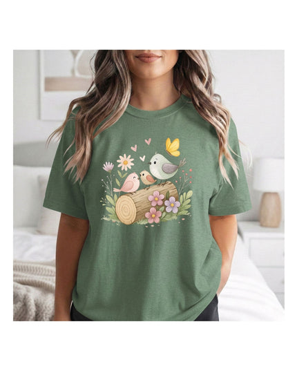 Person wearing a green t-shirt with nature-themed design in a bedroom setting