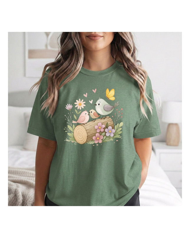 Person wearing a green t-shirt with nature-themed design in a bedroom setting