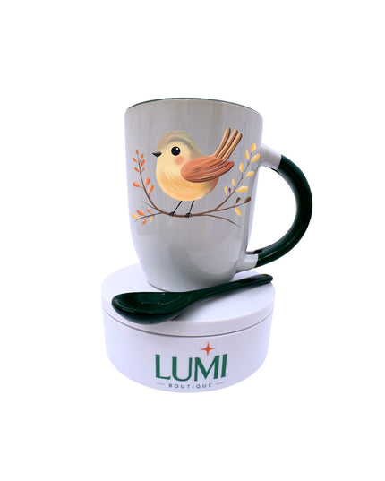 Mug with bird design and spoon on a white background, featuring the LUMI Boutique brand.