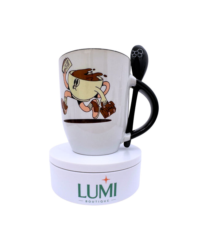 White mug with cartoon character and black handle on a white background, featuring the LUMI Boutique logo.