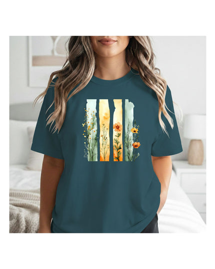  a teal t-shirt with a nature-themed design 