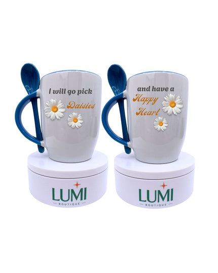 Two mugs with blue handles and floral designs, featuring text and LUMI branding, on a white background.