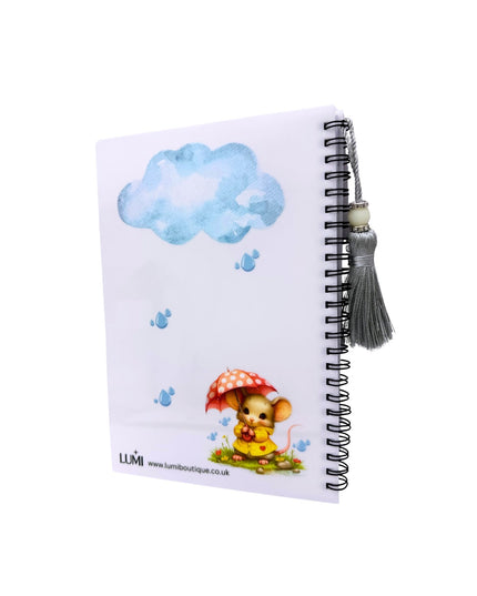 Notebook with a character holding an umbrella and a cloud design on the cover, featuring the brand 'LUMI'.