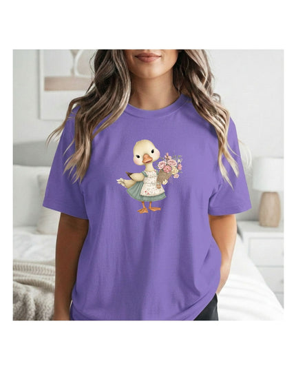 Person wearing a purple t-shirt with a graphic of a duck holding flowers.