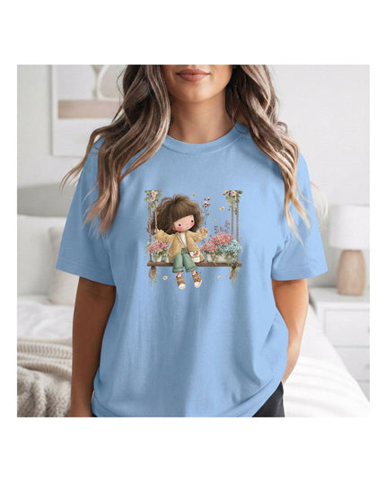  a light blue t-shirt with a graphic design of a girl on a swing.