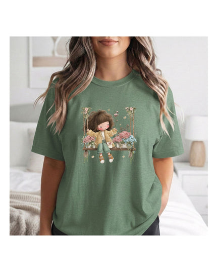 a green t-shirt with a graphic design of a girl on a swing.