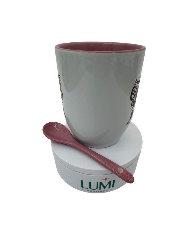 White mug with red interior and spoon on a white base with LUMI branding.