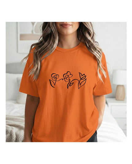 an orange t-shirt with a black floral design 