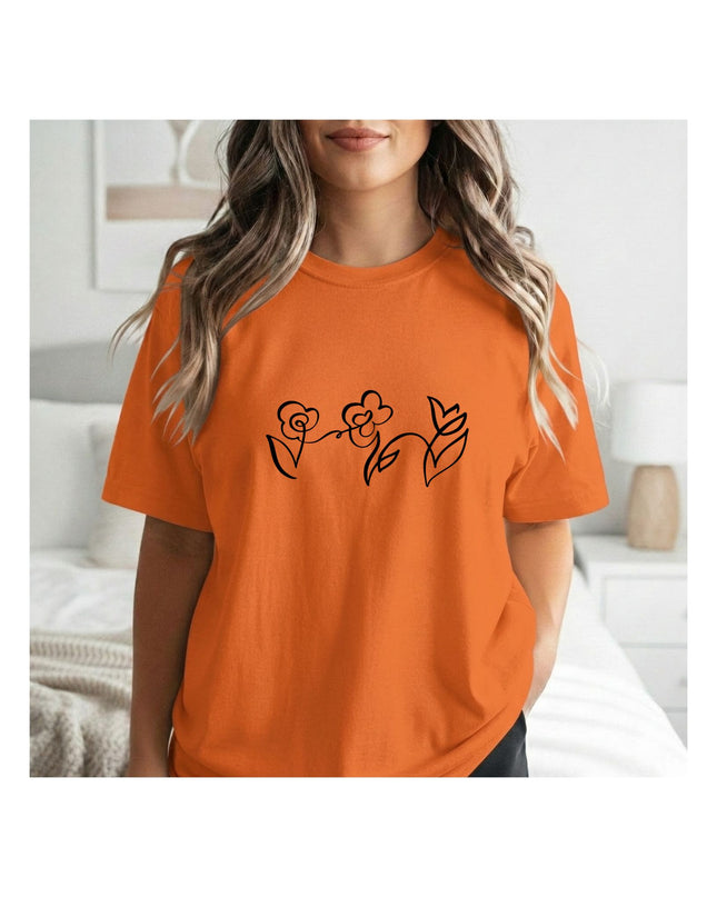 an orange t-shirt with a black floral design 