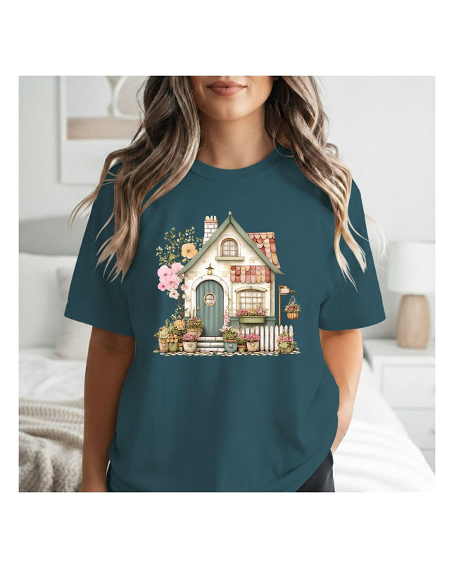 a teal t-shirt with a house and garden design