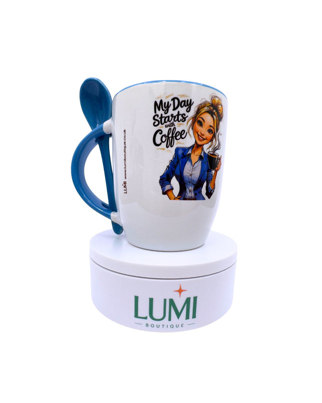 White mug with blue handle featuring a cartoon character and text, on a white stand with 'LUMI Boutique' branding.