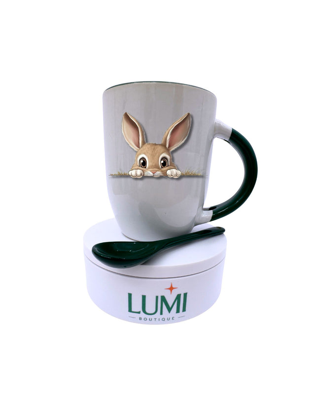 Mug with rabbit design and spoon on a white background, featuring the brand 'LUMI Boutique'.