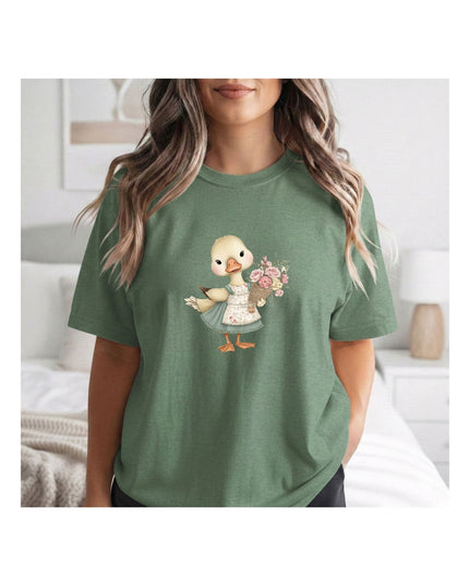 Person wearing a green t-shirt with a cartoon duck design holding flowers.