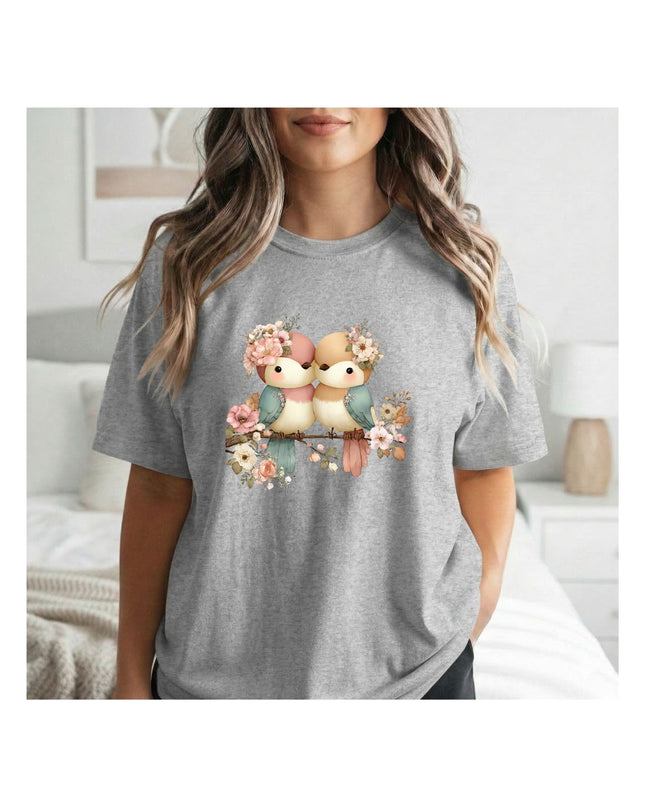  a gray t-shirt with a graphic design of two birds and flowers 