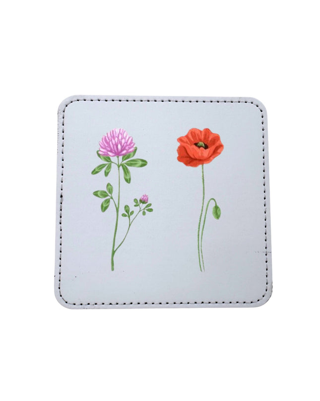 Square coaster with floral designs on a light blue background