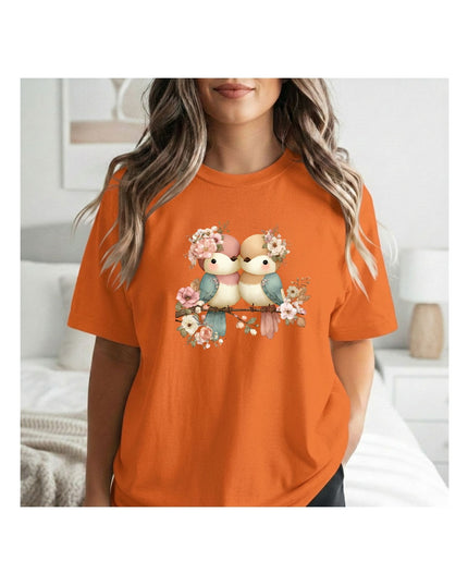  an orange t-shirt with a graphic design of two bears and flowers.
