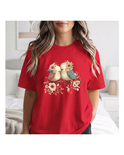 a red t-shirt with a graphic of two birds and flower.