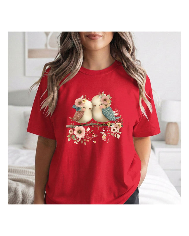 a red t-shirt with a graphic of two birds and flower.