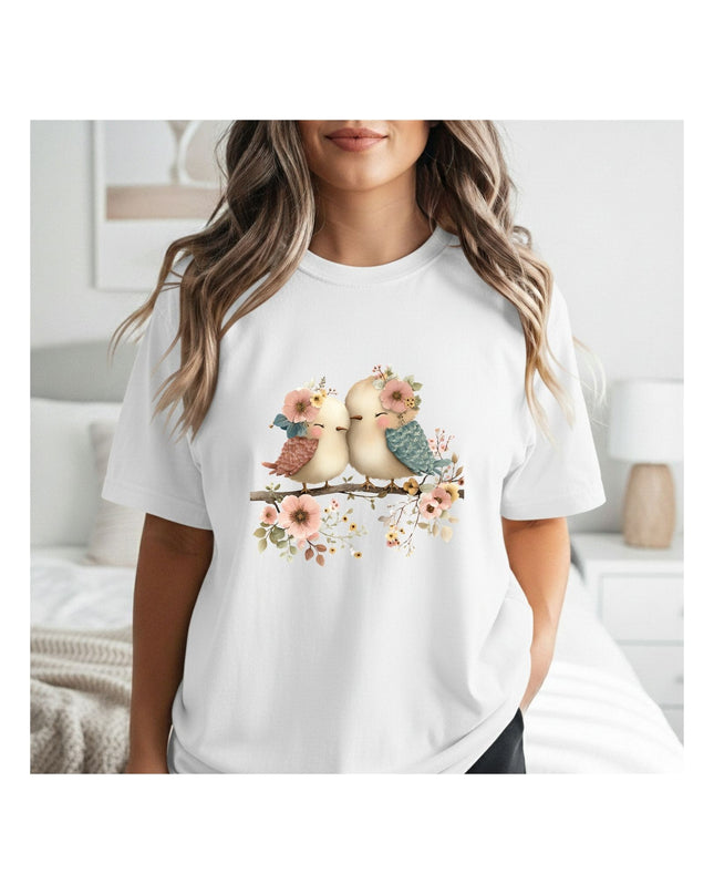  a white t-shirt with a graphic of birds and flowers.