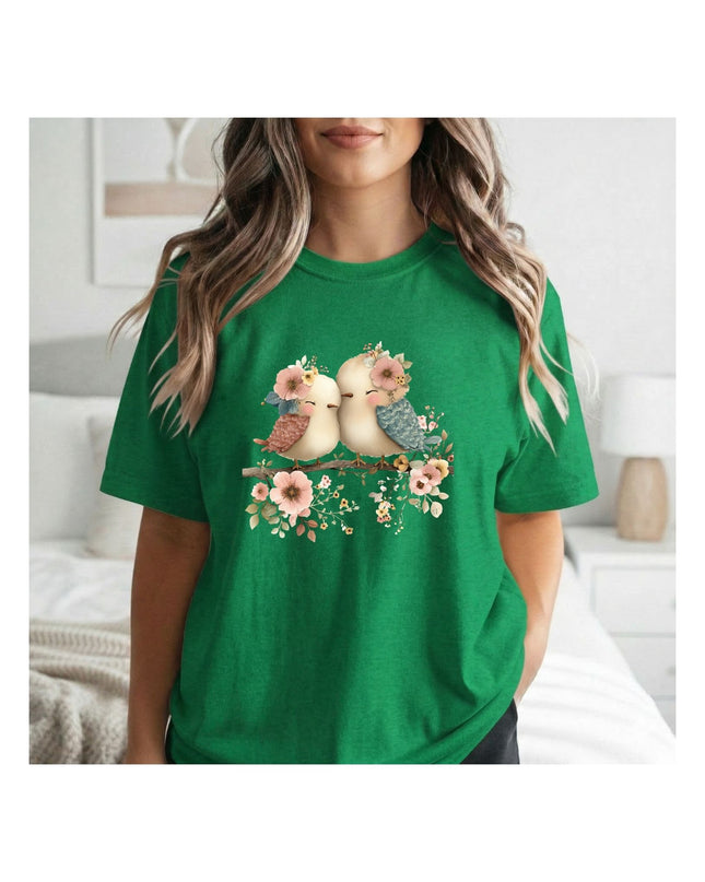  a green t-shirt with a graphic design of two birds and flowers.