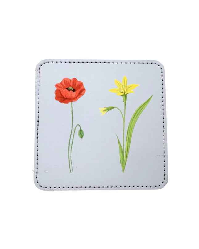 Square coaster with floral designs on a light blue background