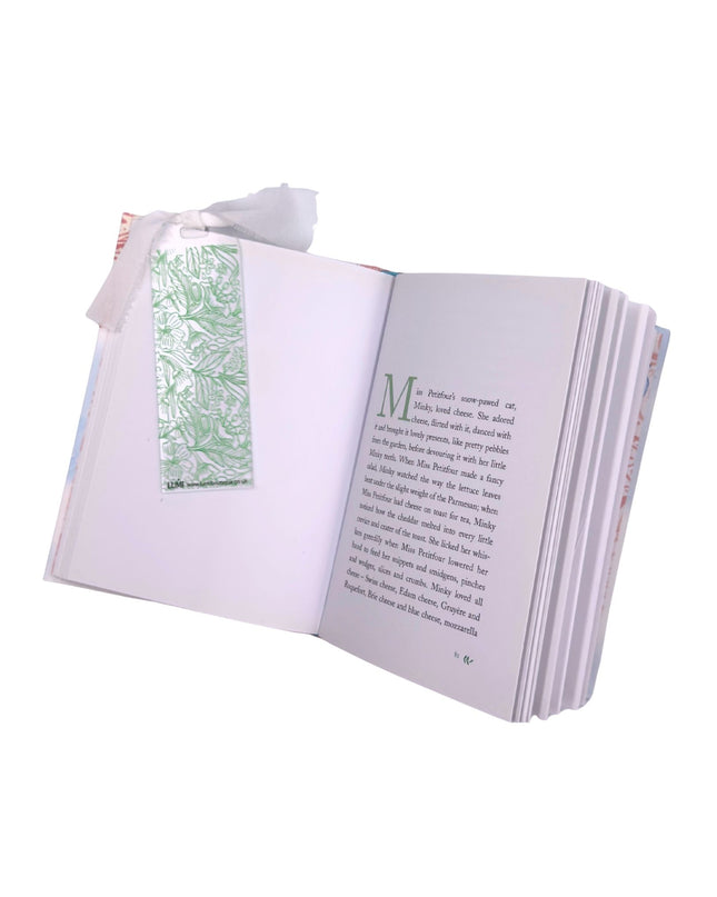 Open book with a green bookmark on a white background